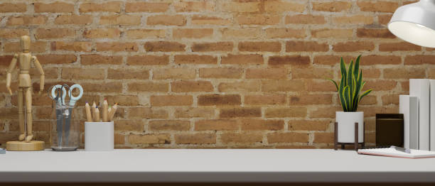 istock Contemporary working space with stationery, supplies, decorations and copy space on the table with brick wall, 3D rendering 1319710771