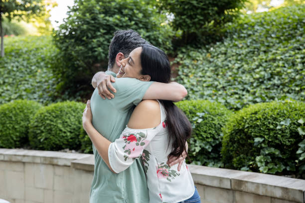 istock Mature couple give hugs while greeting each other 1319711549