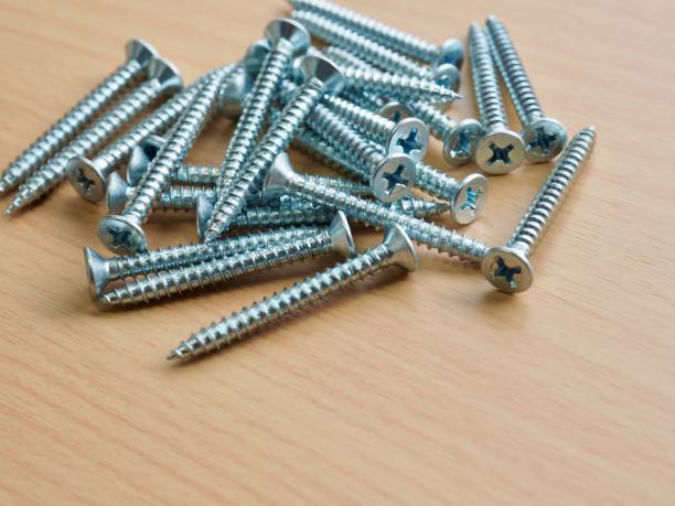 istock Wooden board background with silver screws 1319711914