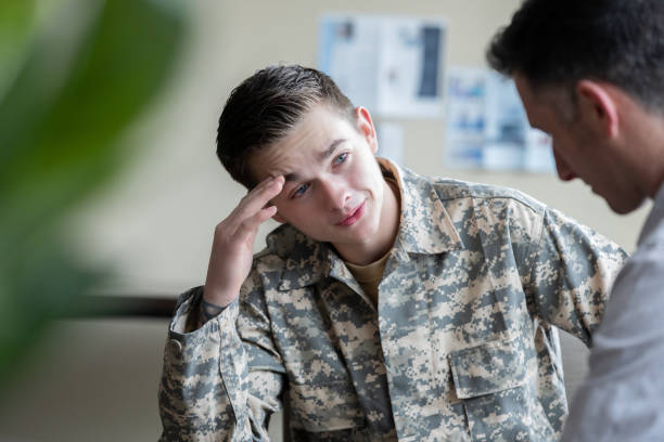 istock Young adult military man talking during one on one therapy session 1319713344