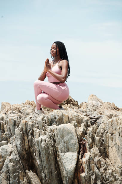 istock Woman doing cross legged squat 1319716947