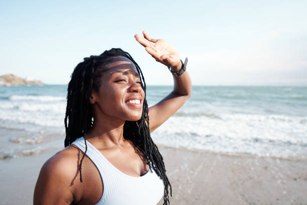 istock Beautiful woman on sunny beach 1319717653