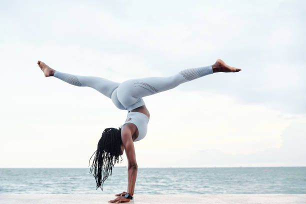 istock Woman doing handstand with splits 1319717654
