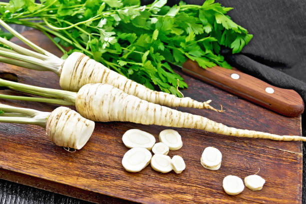 istock Parsley root chopped with knife on dark board 1319720898