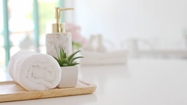 istock Roll up of white towels on white table with copy space Spa concept 1319721729