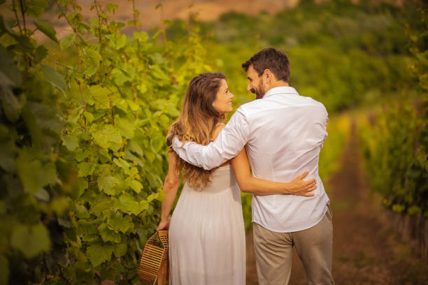 istock Couple standing and talking in vineyard. 1319725674