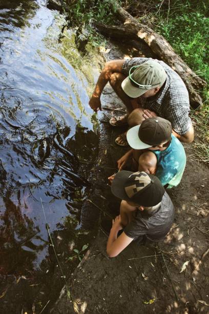 istock Father and Children Feed Freshwater Eels 1319726418