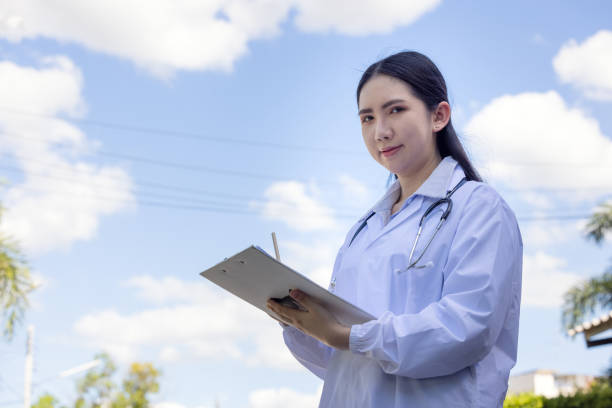 istock Doctors reviewing medical documents outdoors 1319729068
