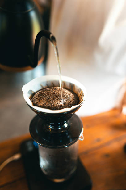 istock Drip coffee, barista pouring water on coffee ground with filter 1319730204