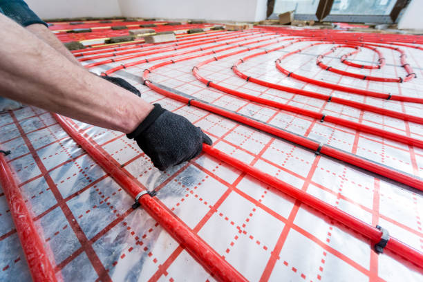 istock Pipefitter install system of underfloor heating system at home 1319732328