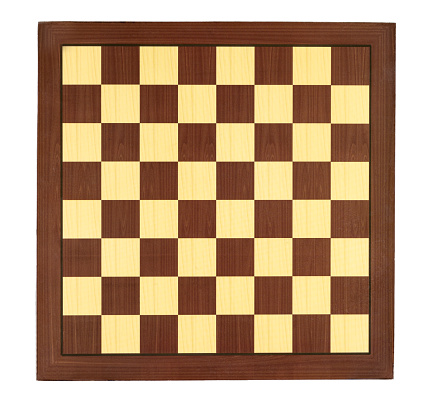 The chess game board is photographed against a light background and with the addition of the chess player's glasses