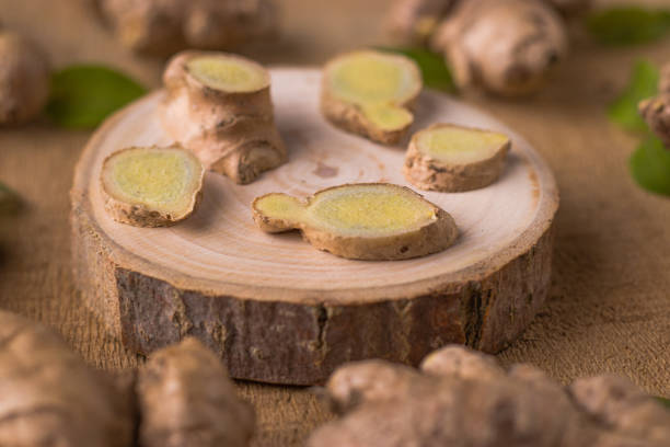istock Fresh Ginger on wooden texture background stock image. 1319733843