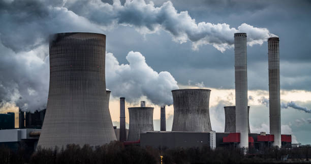 istock Power plant with smoke stacks and cooling towers 1319734715