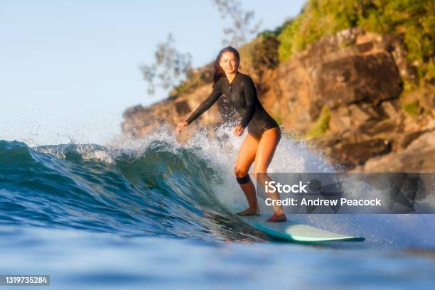 A Woman Is Surfing A Wave At Noosa National Park Stock Photo - Download Image Now - Noosa Heads, Surfing, Australia