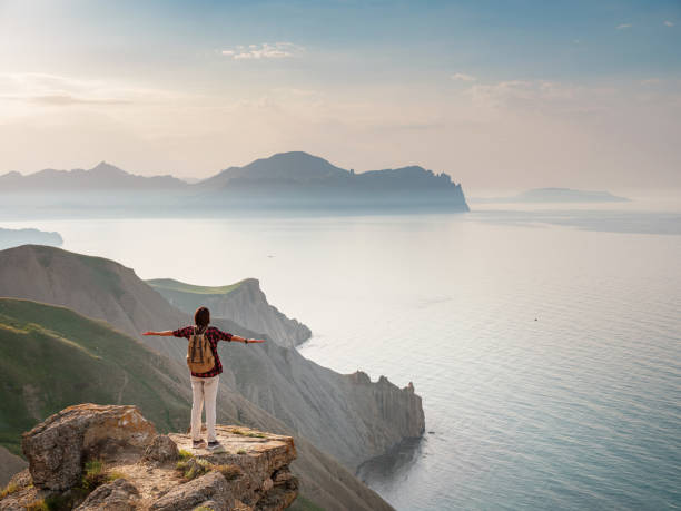 istock A young Asian woman with a backpack hiking in the summer. 1319736701