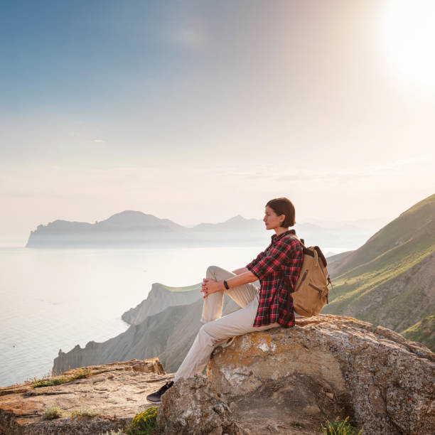 istock A young Asian woman with a backpack hiking in the summer. 1319737544