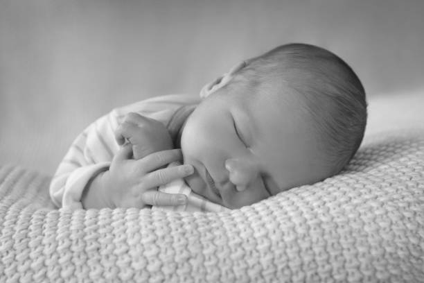istock The baby boy is sleeping on a soft blanket. 1319739685