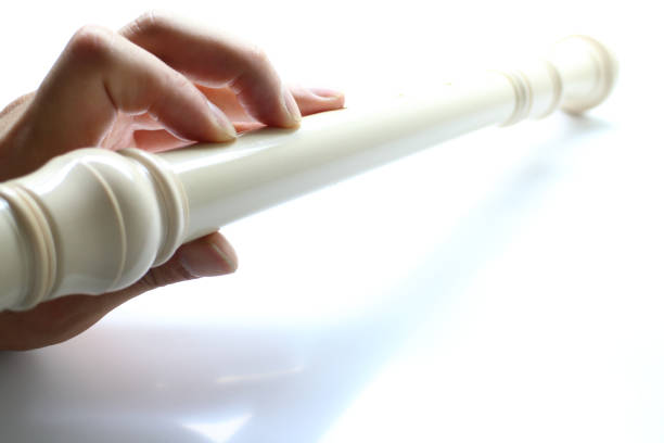 Hands of a woman playing the flute - close up.