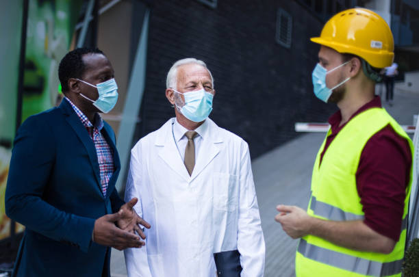 istock Business man, doctor and engineer talking on street. 1319740919