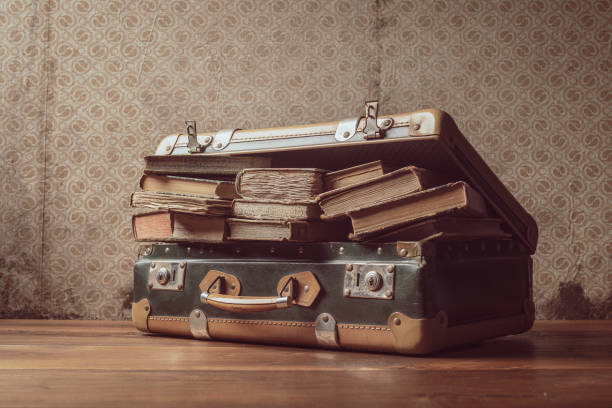 istock Vintage suitcase full of old books 1319741940