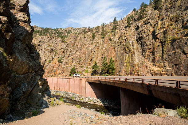 Big Thompson river canyon and highway bridge in sunny daytime. Colorado, USA