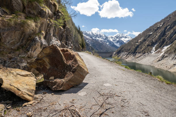 istock A rock has fallen on the alpine road, no way trough 1319744582