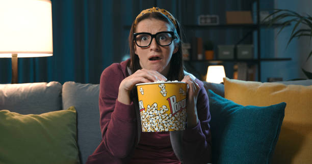 istock Woman watching a scary movie alone 1319744749