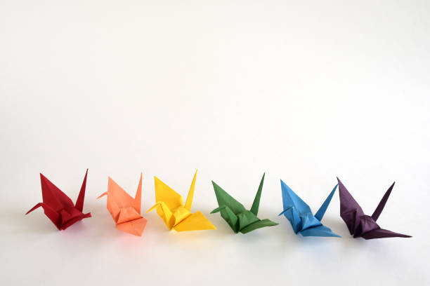 istock LGBT rainbow colored Origami paper cranes on white background. 1319747424