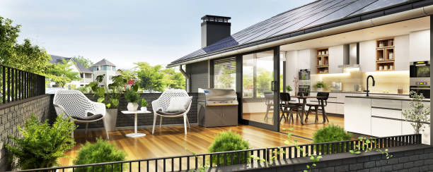 Solar panels on the roof of a modern house Solar panels on the roof of a modern house. Beautiful house with white kitchen, large windows and a terrace modern cottage interior design stock pictures, royalty-free photos & images