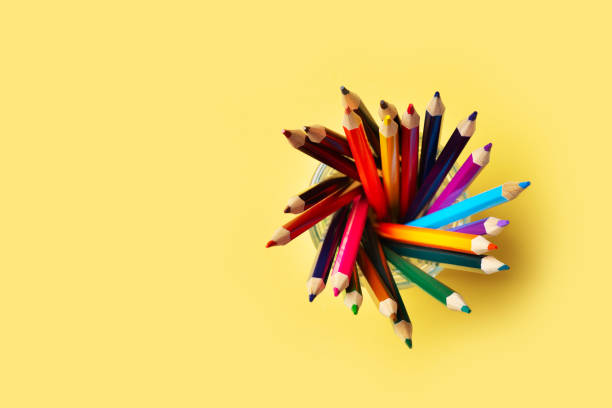 istock Colorful pencils above on yellow background, back to school theme 1319748780