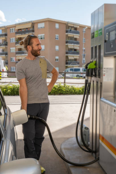istock Young man refuelling his car at a gas station 1319748983