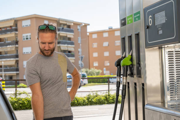 istock Young man refuelling his car at a gas station 1319749113
