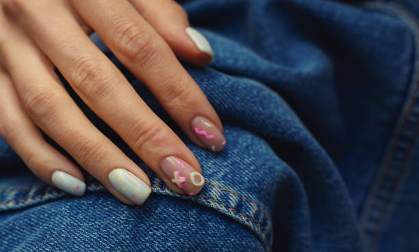 istock Beautiful summer female manicure on denim background 1319752888