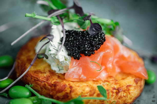 Potato pancakes with light cheese and salmon Potato pancakes with cheese and salmon for breakfast in a cafe caviar stock pictures, royalty-free photos & images