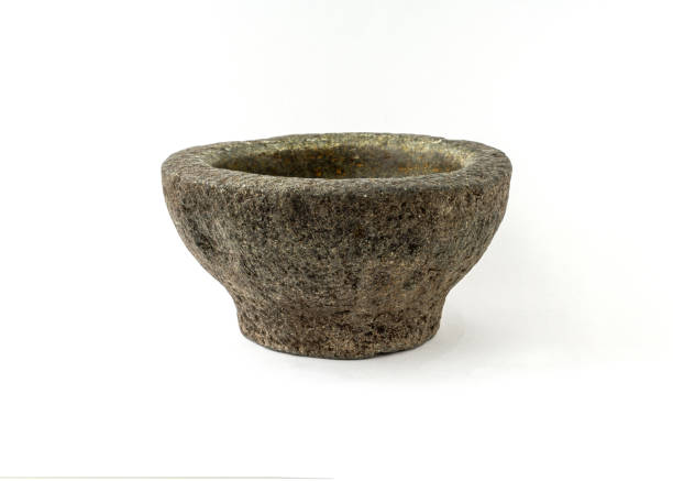 istock Old granite pestle and mortar isolated on white background. 1319754452