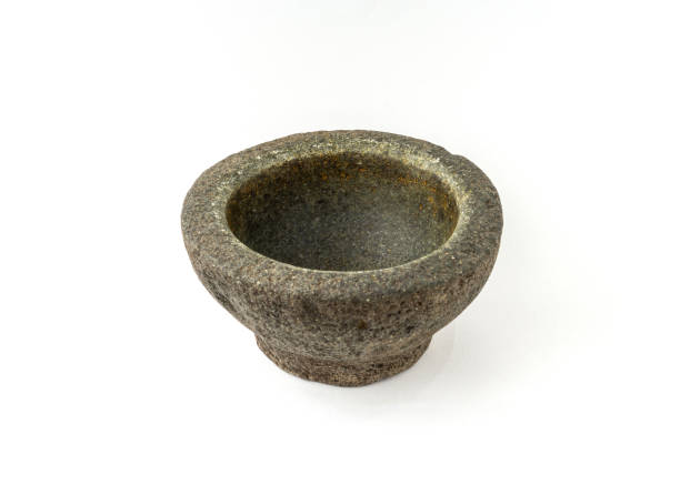 istock Old granite pestle and mortar isolated on white background. 1319754454