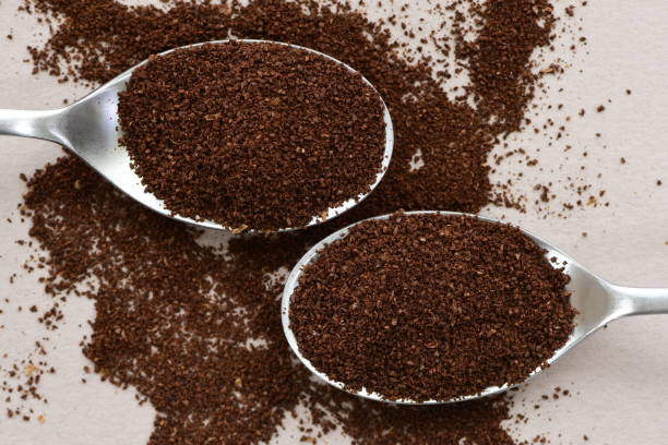 istock Milled fresh coffee powder in two spoons. 1319754484