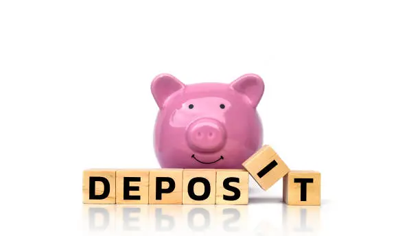 Photo of Deposit messages on square wooden cubes and piggy bank to save money separately on white background.