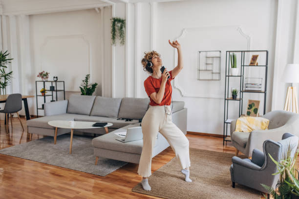 beautiful woman listening music at home - dancing imagens e fotografias de stock