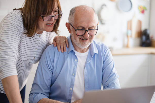 istock Mature couple paying utility bills at home 1319759383