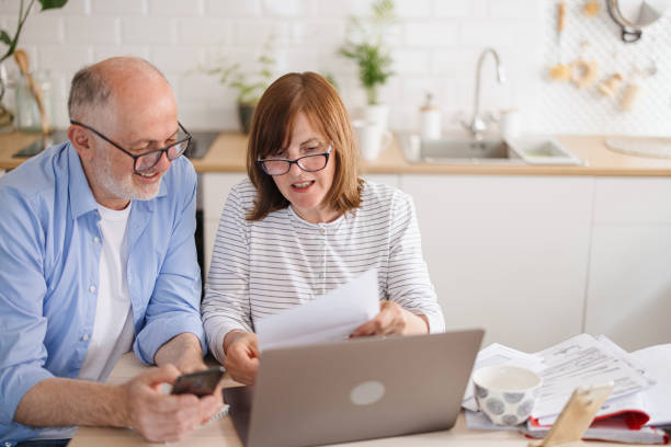 istock Mature couple paying utility bills online 1319759551