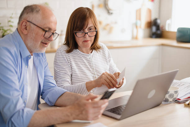 istock Mature couple paying utility bills online 1319759599
