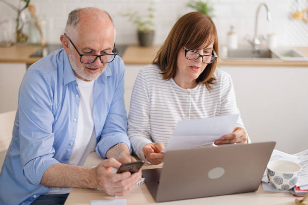 istock Mature couple paying utility bills online 1319759602