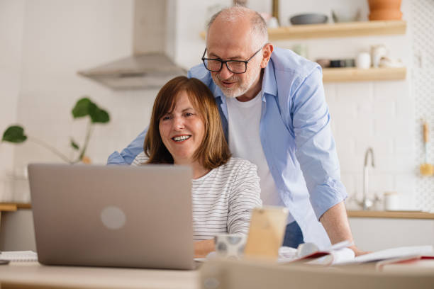 istock Mature couple paying utility bills at home 1319759642