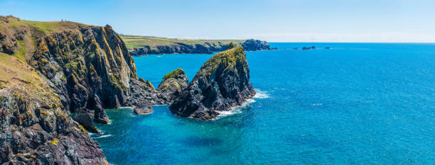 istock Sea stacks cliffs blue ocean panorama Kynanace Cove Cornwall UK 1319760931