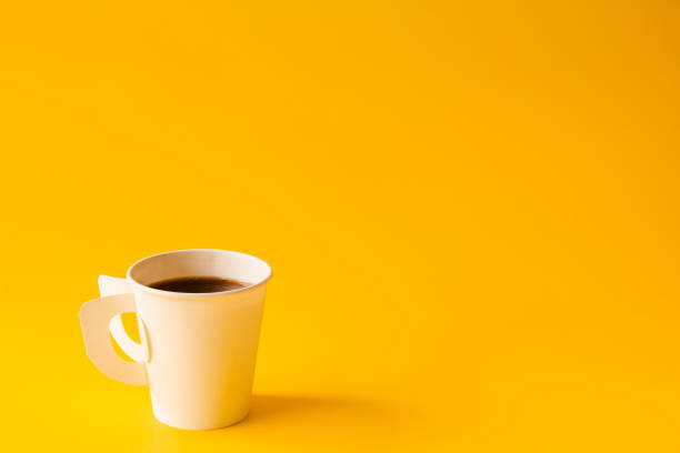 istock Hot Coffee cup on yellow paper minimal style copy space for your text 1319762455