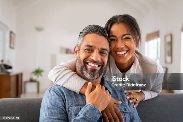 Mature Indian Couple Hugging And Looking At Camera Stock Photo - Download Image Now - Couple - Relationship, Happiness, Smiling