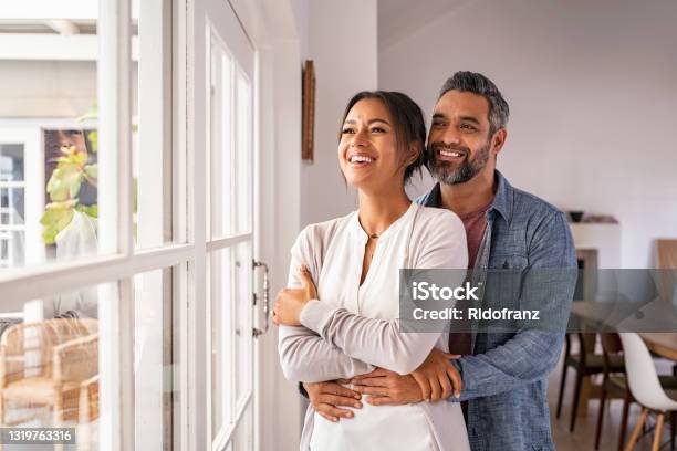 Mature Multiethnic Couple Thinking About Their Future Family Stock Photo - Download Image Now