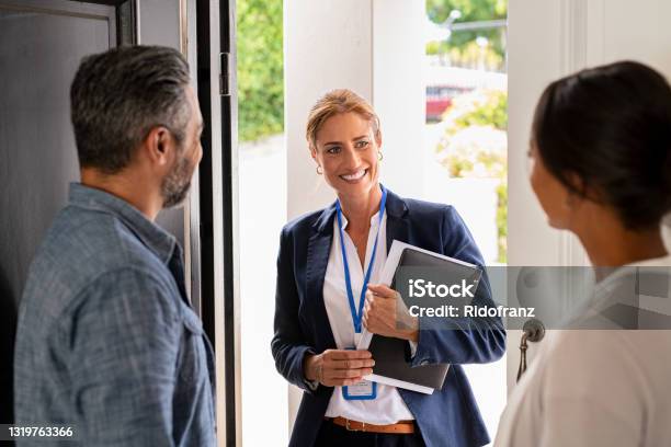 Social Counselor Meeting Couple At Home Stock Photo - Download Image Now - Real Estate Agent, Door to Door Salesperson, Social Worker