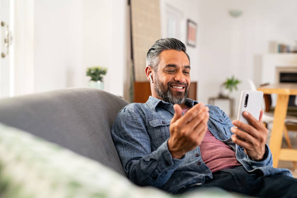 istock Mixed race man in video call with smartphone 1319763395